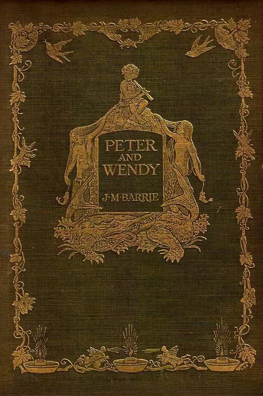 The green cloth cover of Peter and Wendy by J. M. Barrie, stamped in gold with a boy playing pipes above two mermaids, inside a border of leaves and birds